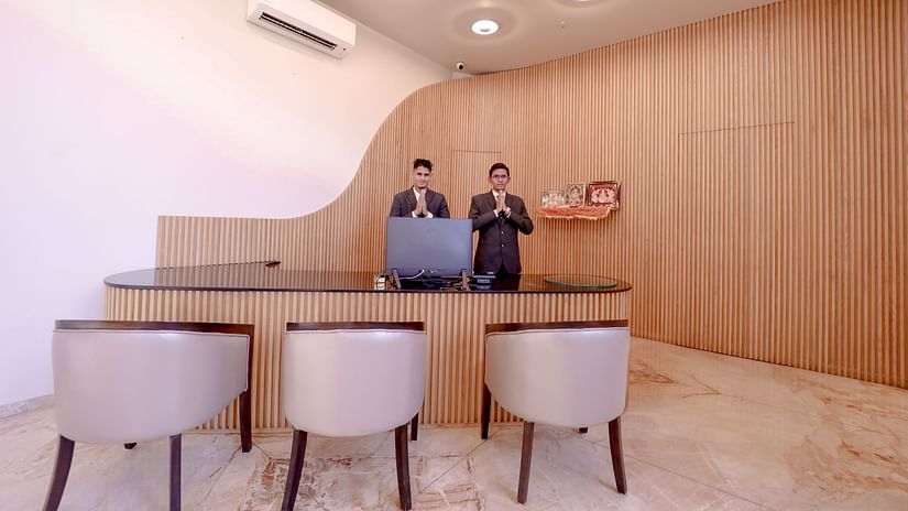 An image of two receptionist with joined hands as a way to greet their guests at Pride Resort Ambaji
